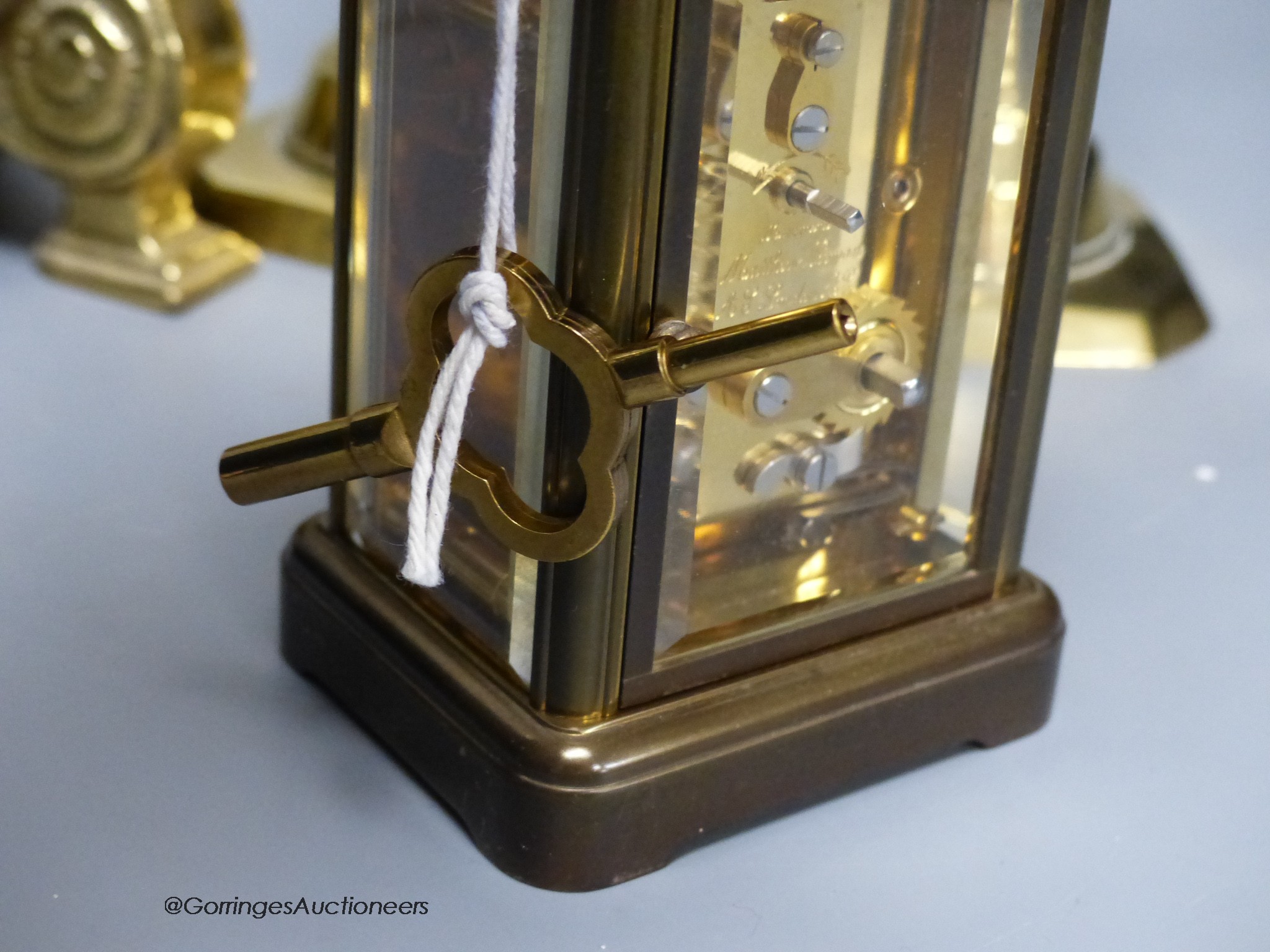 A Matthew Norman brass carriage clock, No.1754 together with a pair of brass candlesticks and a table lamp